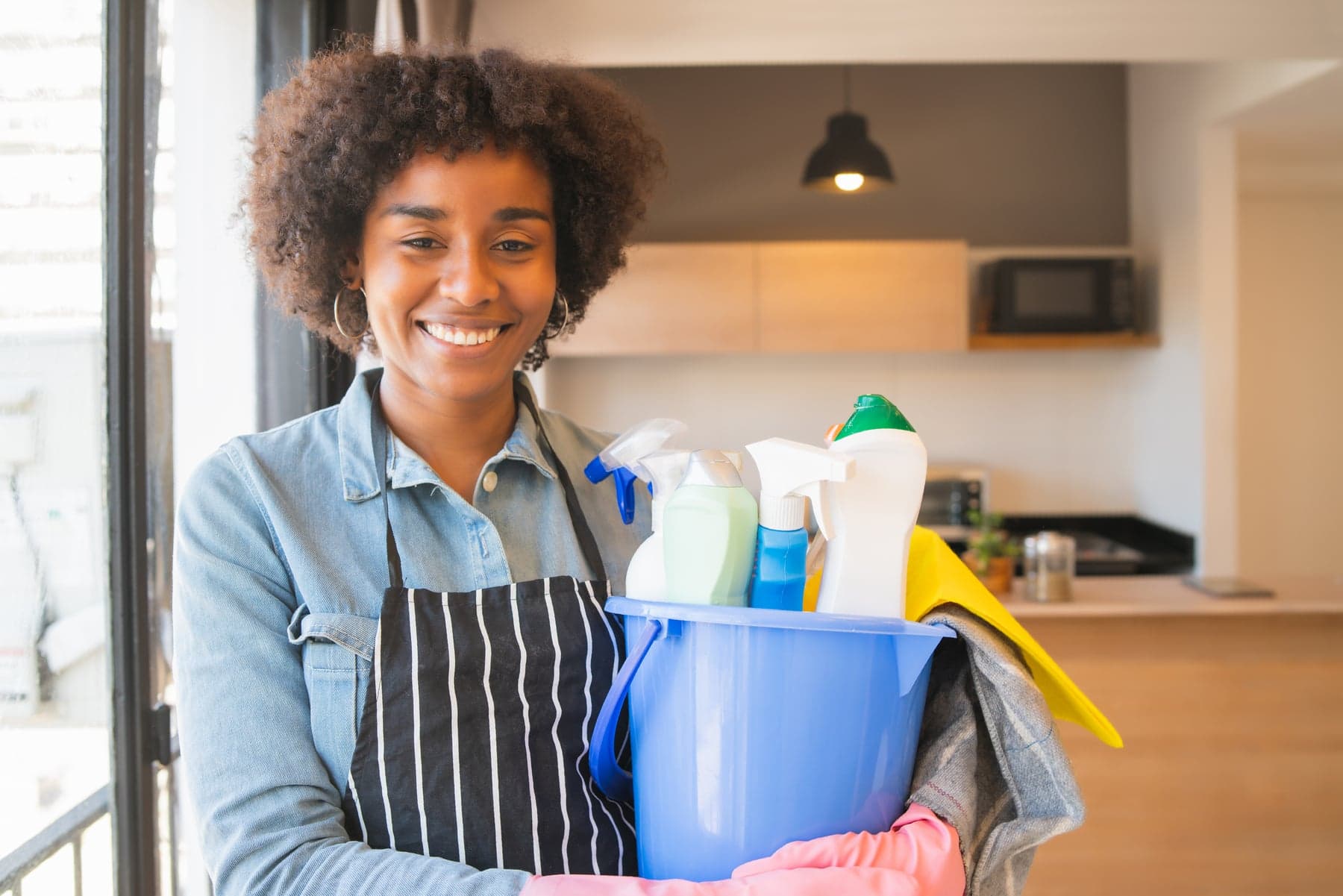 A vetted Taskbed housekeeper with her cleaning supplies